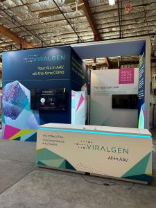 RENTAL: Gravitee Island Design with Conference Room, Storage Room, Ceiling Canopy, Double-Sided Lightbox Supporting the Canopy, (2) Large Monitor Mounts with Internal Extrusion Supports, (2) RE-1576 White Laminated Counters with Recessed LED/RGB Lighting,